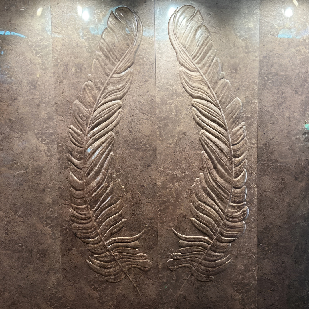 Premium fabric-backed stainless steel wall panel with elegant sculptural dual feathers in rich metallic finish